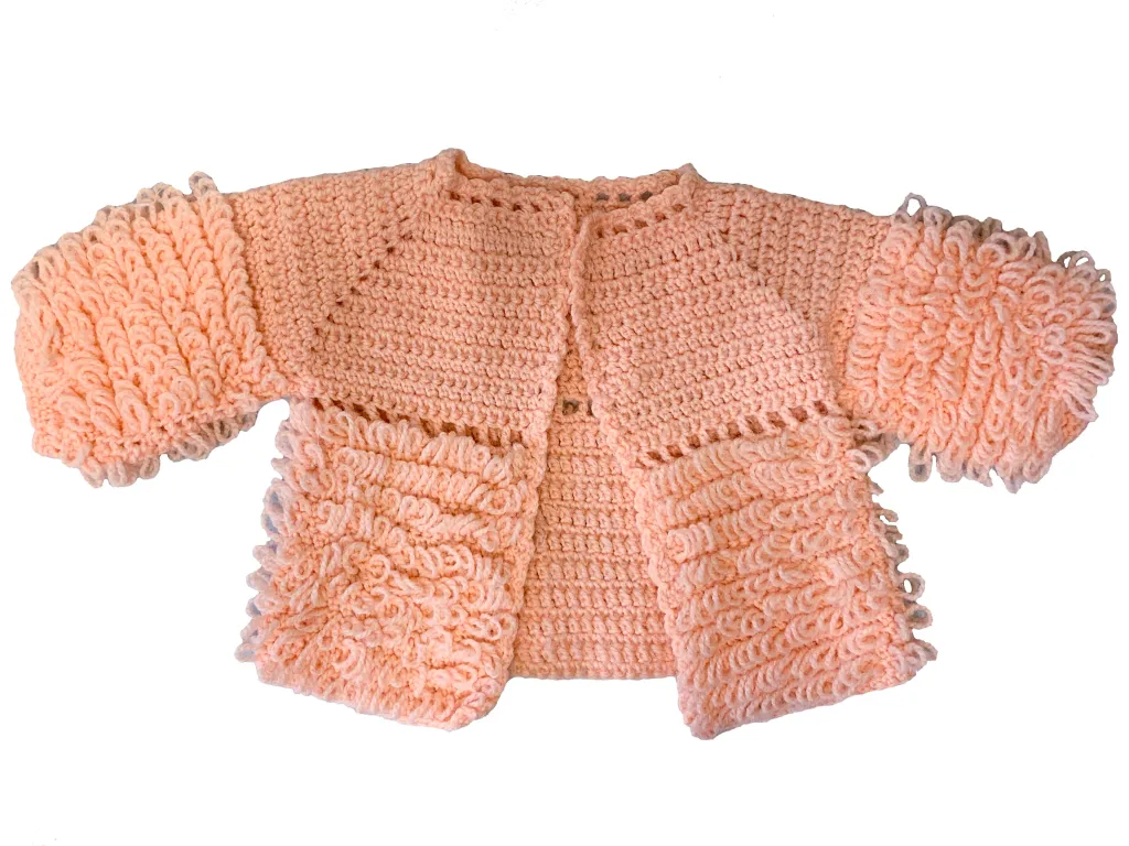 Photograph of a pink crocheted short-sleeve sweater with textured stitching and an open front.