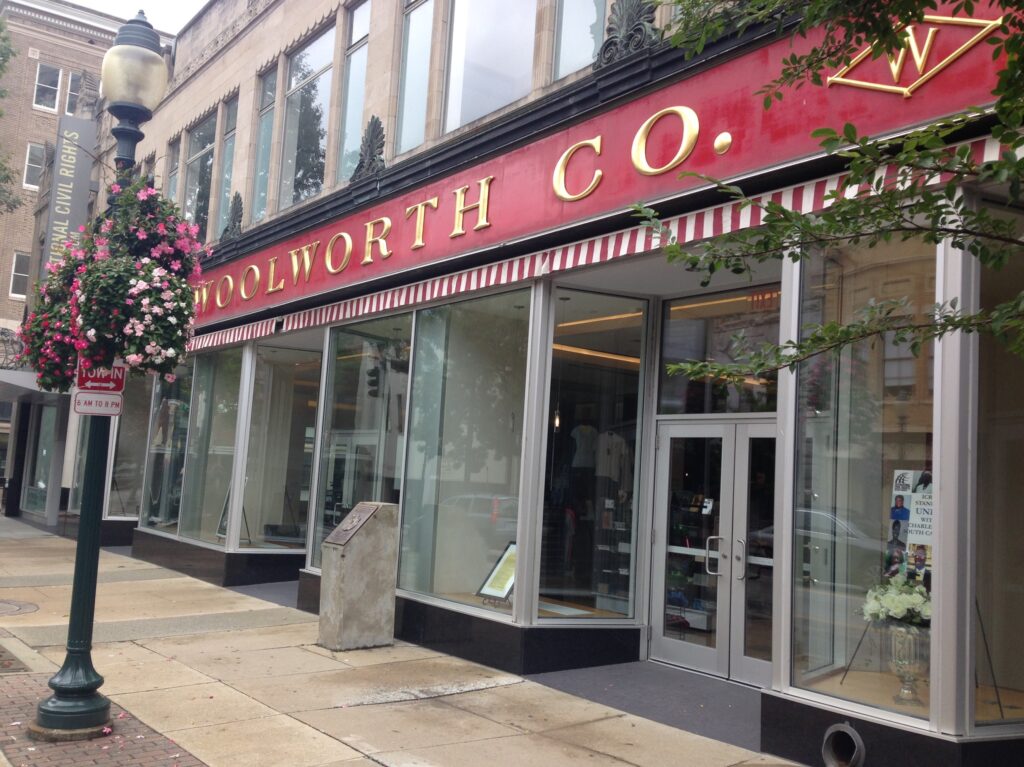Photo of the Woolworth store in Greensboro, North Carolina, with its red and gold storefront sign.