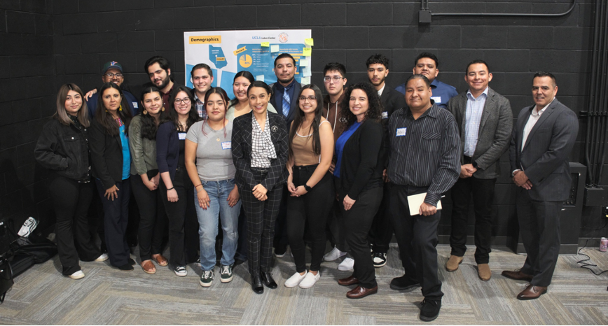 Photo of about twenty organizers smiling, standing, and posing together at the Thriving Youth Study launch event in Oxnard.