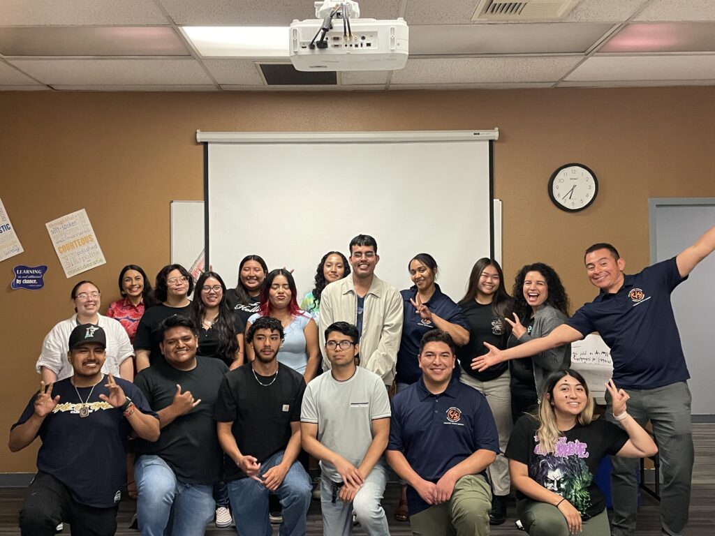 Photo of eighteen student researchers and CSRC staff posing together and smiling after completing data collection for the Thriving Youth Study.